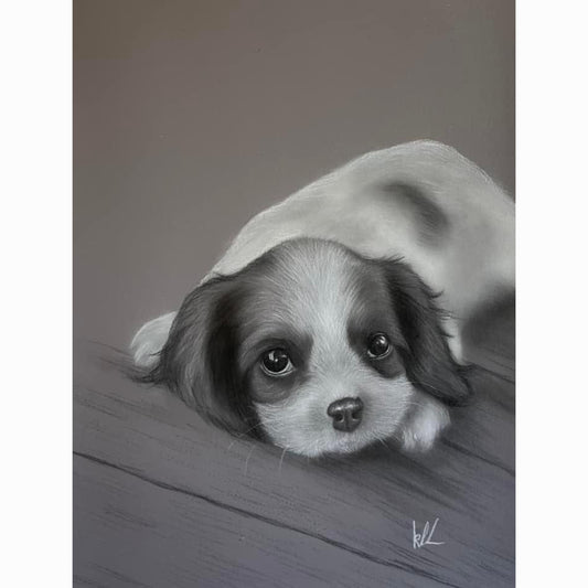 puppy lying on wood floor with eyes open